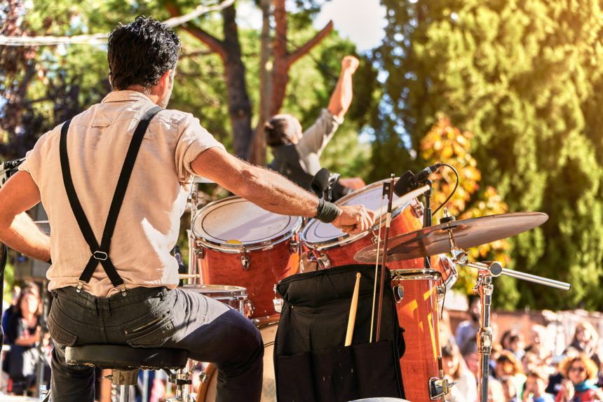 Summer music festival at the park. Music band playing on the stage