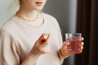 Young Woman Taking Vitamins Close Up